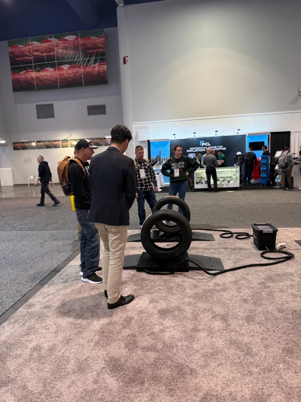 Visitor demonstration at the TreadPlus tire-inspection display at SEMA 2024